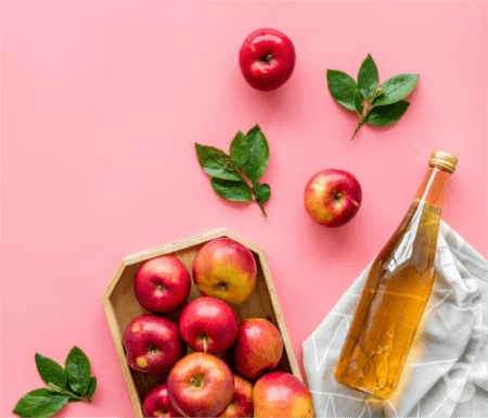 a-bottle-of-apple-cider-vinegar-with-several-apples
