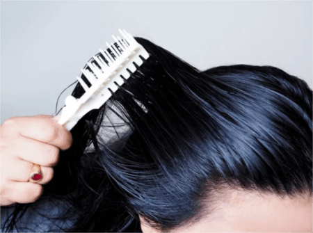 a-woman-combing-hair-with-an-oily-scalp