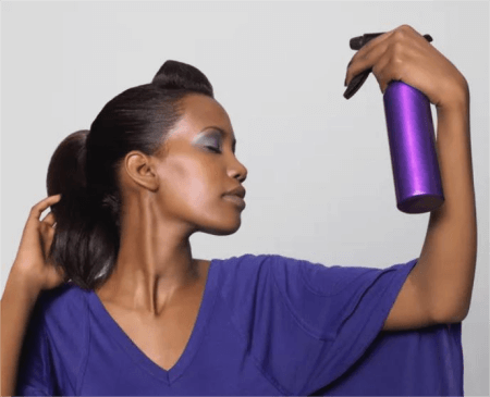 a-woman-holding-hair-spray
