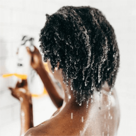 a-woman-washing-her-hair-before-using-acv