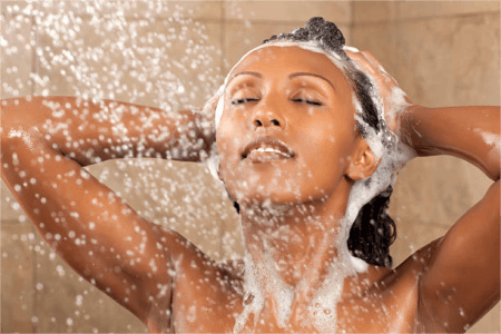 a-woman-washing-her-hair-with-hot-water