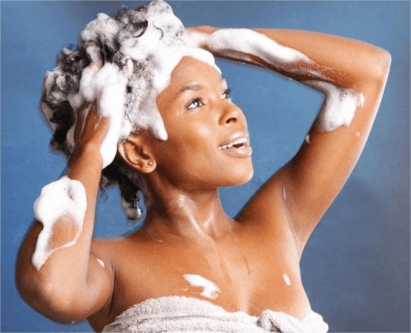 a-woman-washing-her-hair-with-shampoo