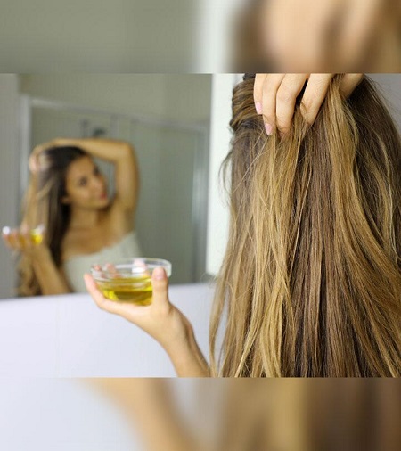 a_girl_is_doing_hot_oil_treatment_for_hair